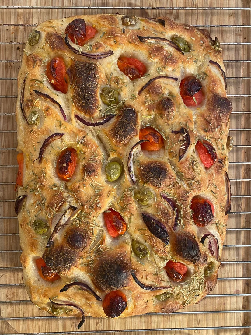 Focaccia with tomatoes, olives and herbs